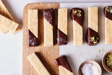 Bars of shortbread dipped in tempered chocolate and sprinkled with salt and pistachios