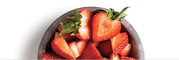 Sliced strawberries in a bowl